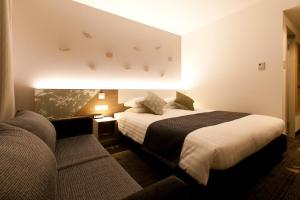 Ліжко або ліжка в номері Toyama Excel Hotel Tokyu