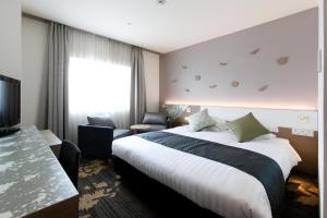 Ліжко або ліжка в номері Toyama Excel Hotel Tokyu