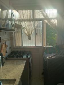 a kitchen with a stove and a window at Só o Quarto para você! in Rio de Janeiro +16 photos
