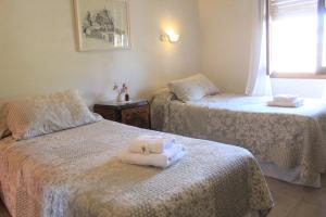 a room with two beds with towels on them at Alta Gracia Hotel Boutique in Alta Gracia +12 photos