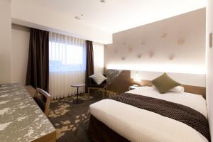 Ліжко або ліжка в номері Toyama Excel Hotel Tokyu