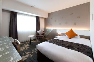 Ліжко або ліжка в номері Toyama Excel Hotel Tokyu