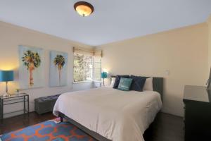 a bedroom with a large bed and a window at West Beach Villa 1 in Santa Barbara