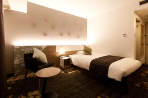 Ліжко або ліжка в номері Toyama Excel Hotel Tokyu