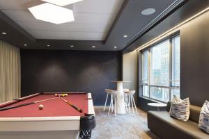 a pool table in a room with a ceiling at Luxury Apartments by Hyatus at Boston Assembly Row in Somerville