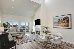 a living room with a couch and a table at Leadbetter Beach Retreat in Santa Barbara