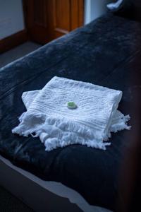 a white towel sitting on top of a bed at 1 BDR Apartment By Eason Stays Short Lets & Serviced Accommodation Lowestoft With Free parking in Lowestoft