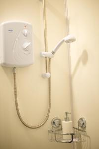 a shower in a bathroom with a shower head at 1 BDR Apartment By Eason Stays Short Lets & Serviced Accommodation Lowestoft With Free parking in Lowestoft
