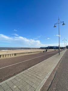 a street light on the side of a beach at One BR Flat By Eason Stays Short Lets & Serviced Accommodation Lowestoft With Free Parking in Lowestoft