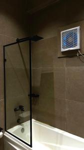 a bathroom with a bath tub and a window at Wazidi Resort in Siwa +49 photos