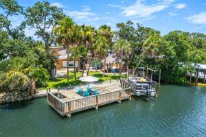 an estate with a dock and a boat on the water at 464 Indian Creek Dr in Cocoa Beach