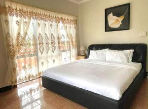 a bedroom with a large white bed and a window at Paradise First Hotel in Nuku‘alofa +8 photos
