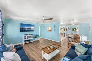 a living room with blue walls and a blue couch at 1375 Bay Shore Drive in Cocoa Beach
