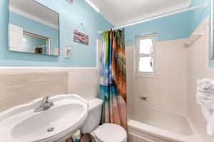 a bathroom with a sink and a toilet and a tub at 1375 Bay Shore Drive in Cocoa Beach +42 photos