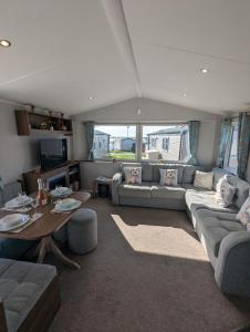 a living room with a couch and a table at Pet friendly holiday home located at Littlesea Holiday Park, In Weymouth, Dorset in Wyke Regis