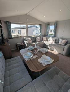 a living room with a couch and a table at Pet friendly holiday home located at Littlesea Holiday Park, In Weymouth, Dorset in Wyke Regis