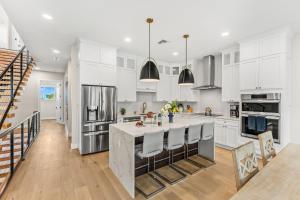 a kitchen with white cabinets and a large island at 40 8th Avenue in Indialantic
