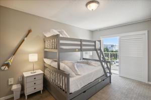 a bedroom with a bunk bed with a ladder at Shorewood 401 in Cape Canaveral