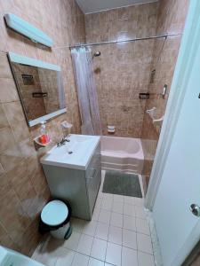 a bathroom with a sink toilet and a tub at Amazing private Room in Glendale