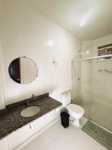 a bathroom with a toilet and a sink and a shower at Pousada da Orla in Itacaré