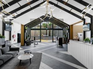 an office lobby with a couch and a table at VAQUAY Belladonna In Abbotsford in Melbourne