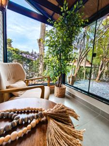 a room with a table and a large window at Refúgio cercado pela natureza em Pomerode in Pomerode