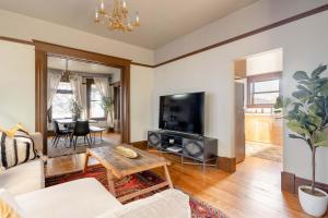 a living room with a couch and a tv at 2BR Historic Soul District Remodel in Portland +17 photos