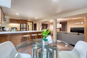 a kitchen with a glass table and white chairs at Stay Portland - 1BR Historic Soul District Remodel in Portland