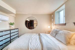 a bedroom with a large bed and a mirror at Stay Portland - 1BR Historic Soul District Remodel in Portland +9 photos