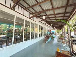 a building with windows and tables and chairs at Port Douglas Backpackers Youth Hostel in Port Douglas