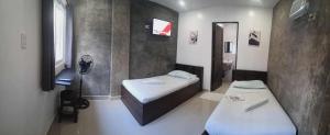 a room with two beds and a mirror in it at Lola's Lodge in Boracay