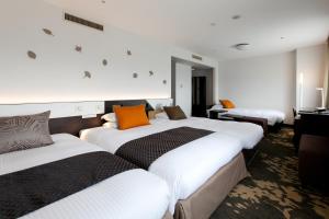 Ліжко або ліжка в номері Toyama Excel Hotel Tokyu