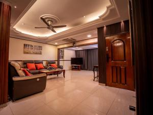 a living room with a couch and a ceiling fan at Cozy-SJ-Family Holidays-Work-BBQ-Tea ceremony-Engagement in Subang Jaya