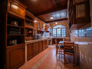 a kitchen with wooden cabinets and a table and chairs at Cozy-SJ-Family Holidays-Work-BBQ-Tea ceremony-Engagement in Subang Jaya