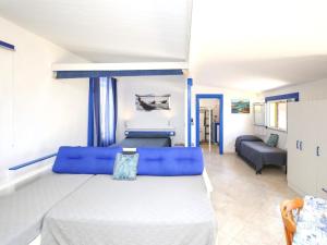 a bedroom with a large bed and a couch at Holiday home with sea view and large terrace in Castelsardo