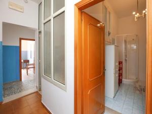 a hallway with a door and a room with a kitchen at Holiday home with sea view and large terrace in Castelsardo +31 photos