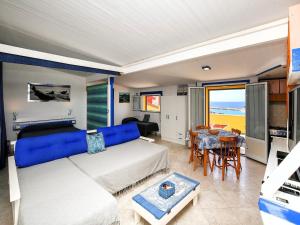 a bedroom with a large bed and a dining room at Holiday home with sea view and large terrace in Castelsardo