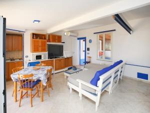 a kitchen and dining room with a table and chairs at Holiday home with sea view and large terrace in Castelsardo