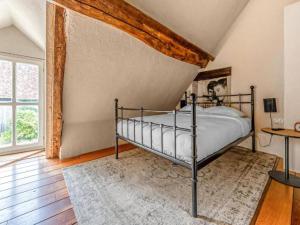 a bedroom with a bed in a room at Gites for 2 people at a chateau with a garden in Palluau-sur-Indre