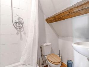 a white bathroom with a toilet and a sink at Gites for 2 people at a chateau with a garden in Palluau-sur-Indre +15 photos
