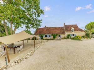 a tent is set up in front of a house at Gites for 2 people at a chateau with a garden in Palluau-sur-Indre
