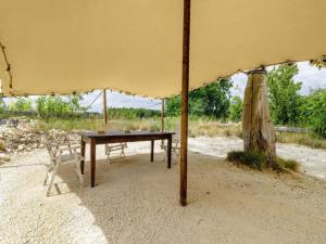 a table and chairs under an umbrella on the beach at Gites for 2 people at a chateau with a garden in Palluau-sur-Indre