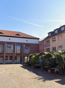 a row of buildings with trees in a courtyard at Ferienwohnung Portofino Edenkoben in Edenkoben