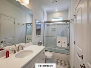 a bathroom with a sink and a toilet and a shower at Oceanside Single Family Brant Beach Beach Badges Rooftop Deck Wifi Private Yard Washer & Dryer in Beach Haven Crest +21 photos