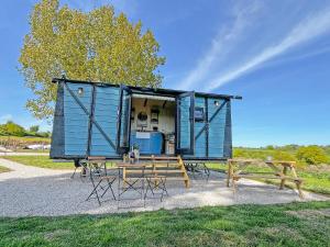 a blue house with a picnic table and a bench at The Carriage - Uk48947 in Shirland