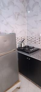 a kitchen with a stove and a refrigerator at Le Nid d'azrou in Azrou