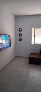 a room with a couch and a clock on the wall at Le Nid d'azrou in Azrou