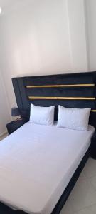 a large bed with two pillows on top of it at Le Nid d'azrou in Azrou +9 photos
