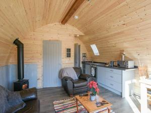 a living room with a couch and a stove at Creyr Glas Pod -Uk41796 in Hirnant