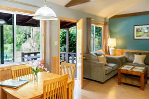 a living room with a table and a couch at Fern River Resort in Felton